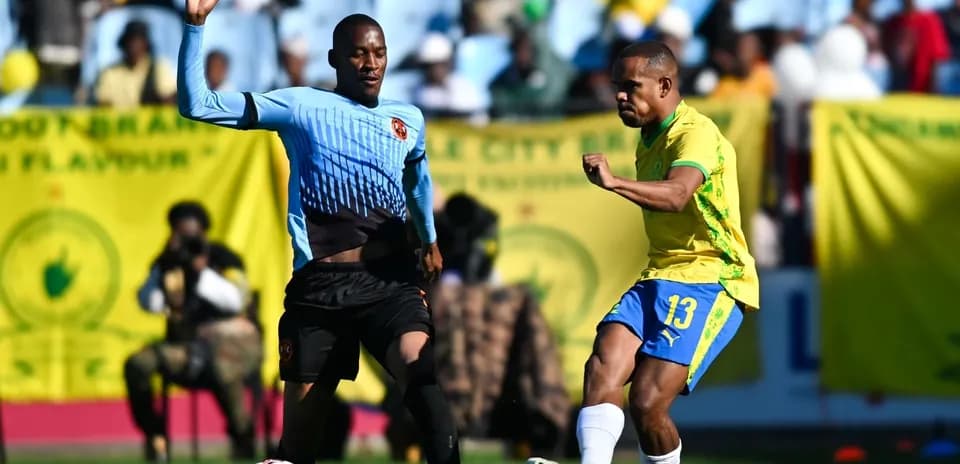 Player dribbling past opponent during football match