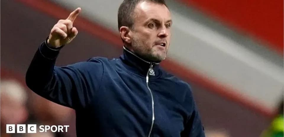 Coach gesturing during a football match