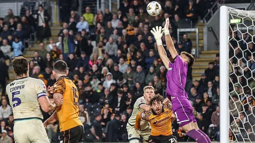 Goalkeeper reaching for the ball during match