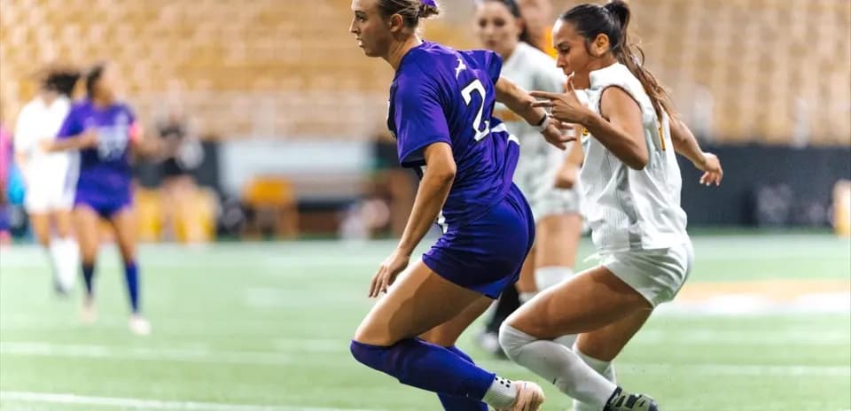 Two players competing for the ball on the field