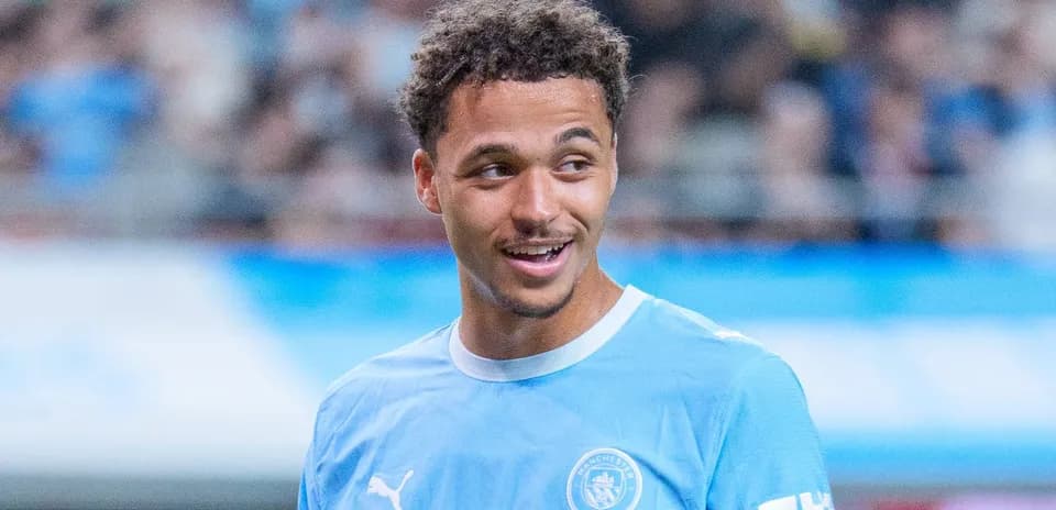 Player smiling during Manchester City warm-up session