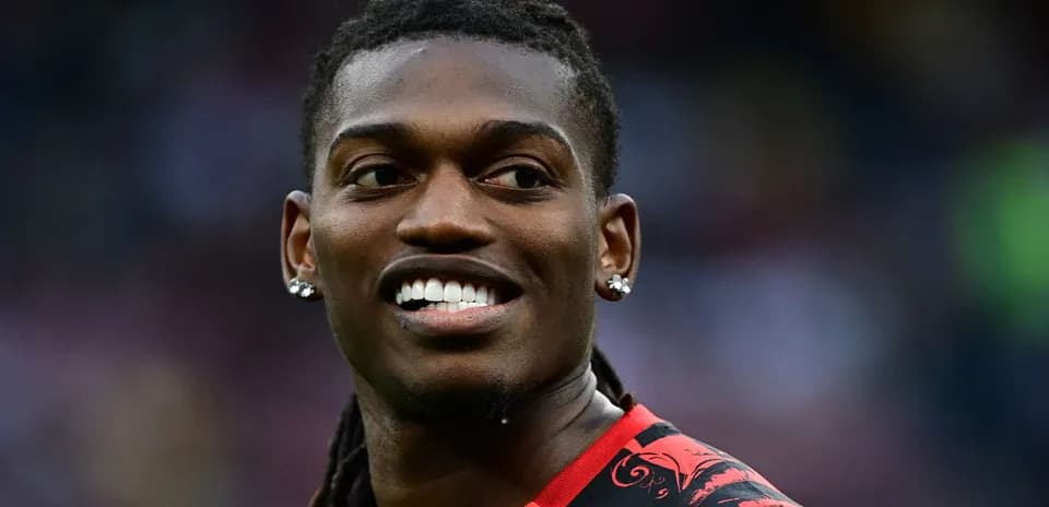 Player smiling while wearing a red and black jersey