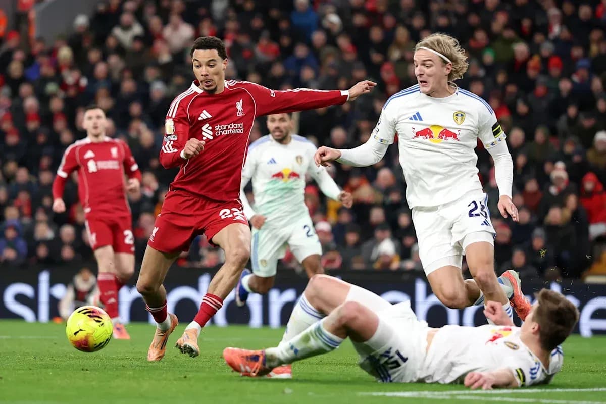 Liverpool player evading challenge from Leeds players