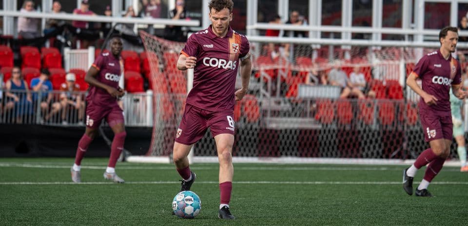 Player dribbling ball during football match