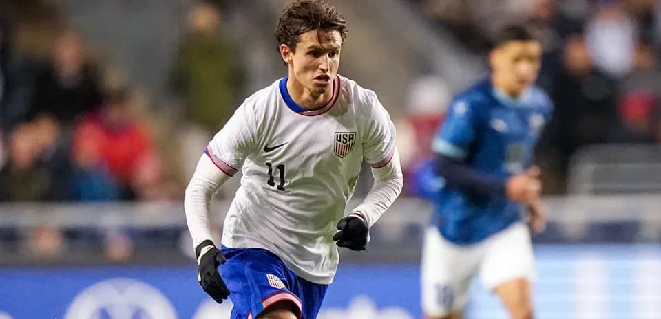 Player wearing USA jersey sprinting on field