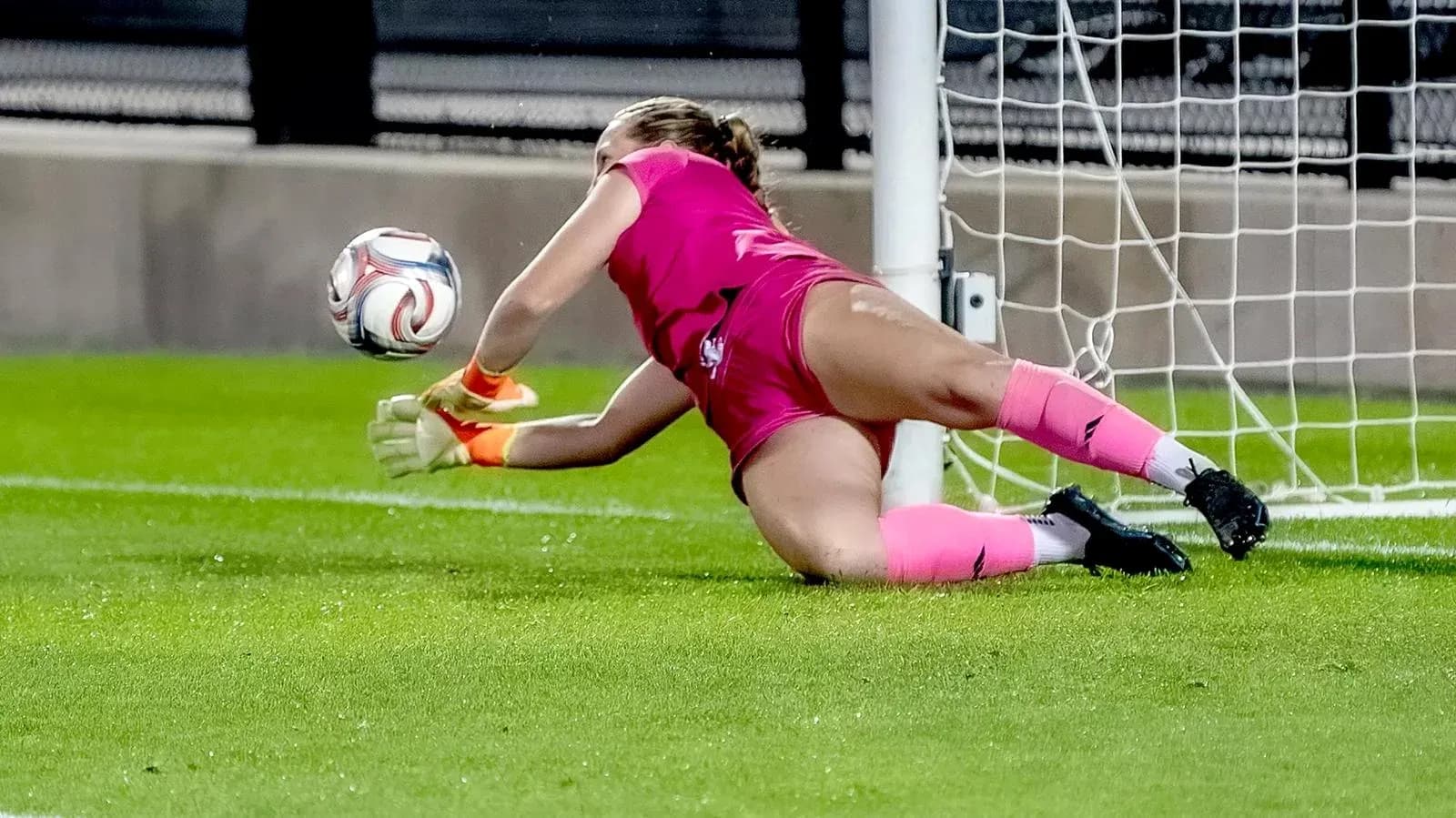 Goalkeeper diving to save the ball in match