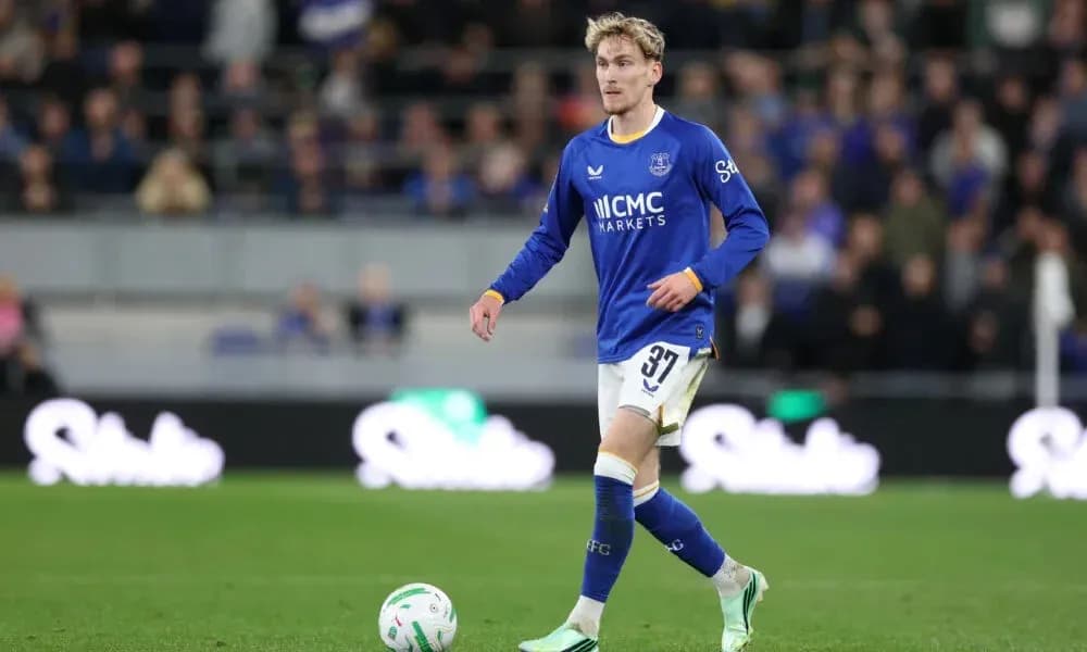 Player in blue kit walking on the pitch