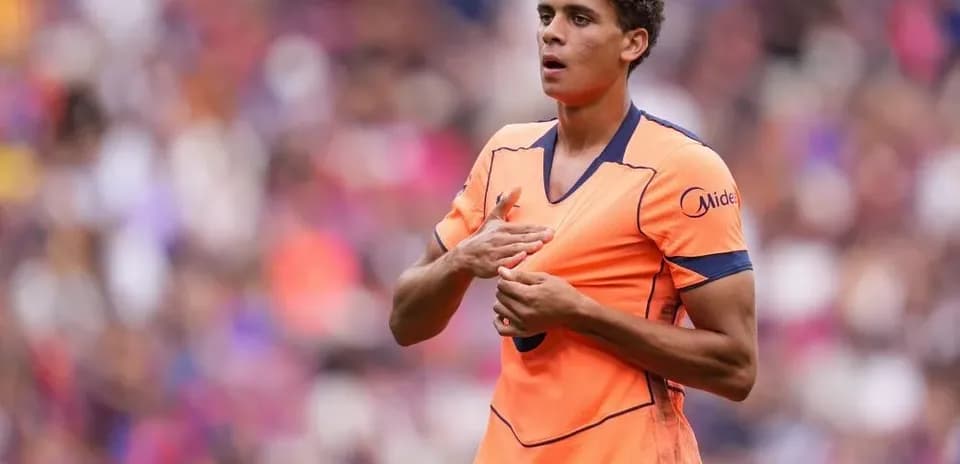 Player gesturing during match in vibrant orange kit