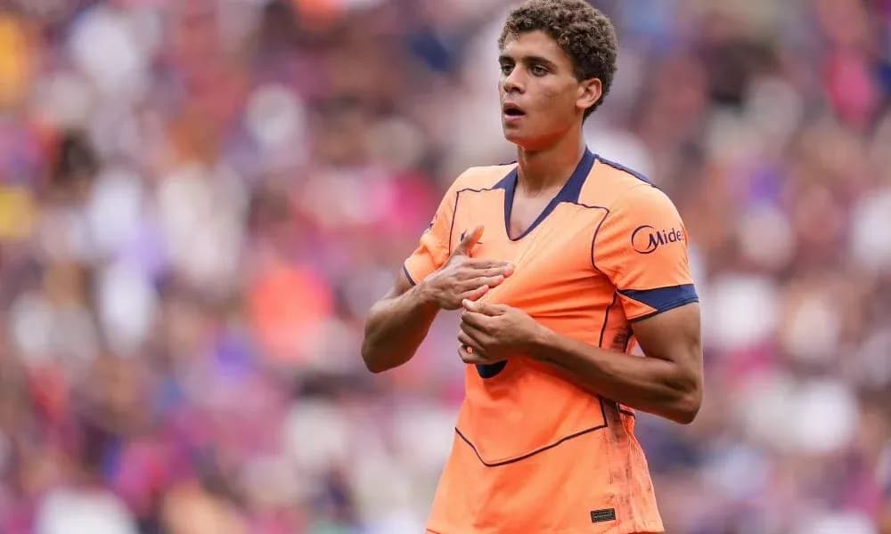 Player gesturing during match in vibrant orange kit