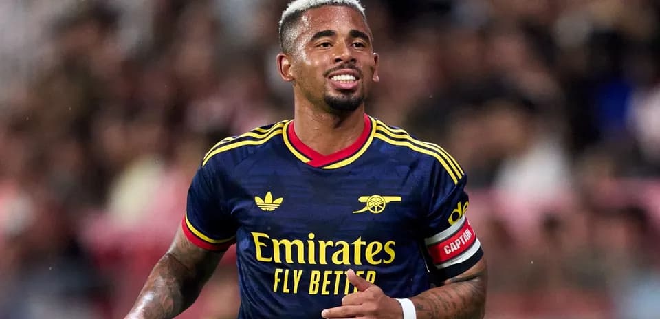 Player celebrating during match wearing Arsenal jersey