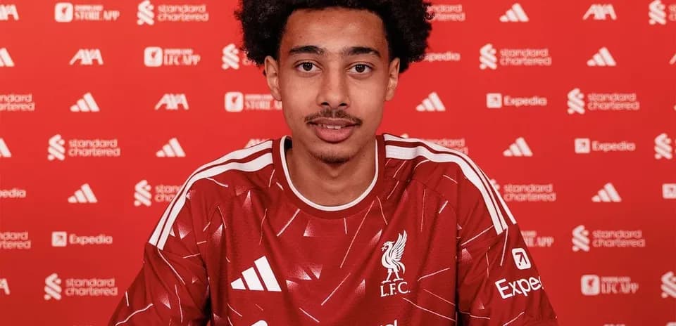 Player signing contract at Liverpool FC announcement event