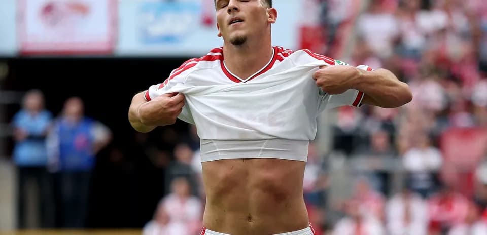 Player lifting shirt during a football match