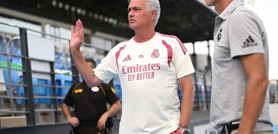 Coach gesturing during conversation on the sidelines