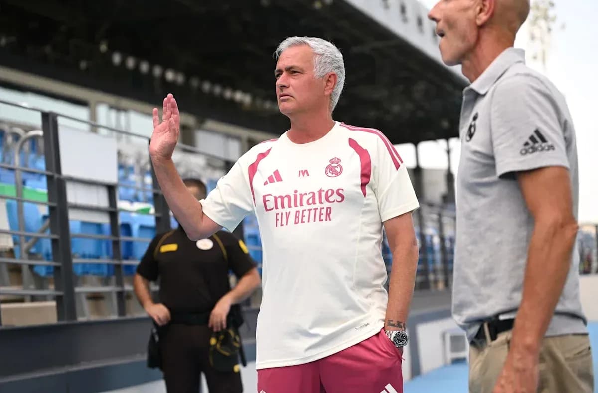 Coach gesturing during conversation on the sidelines