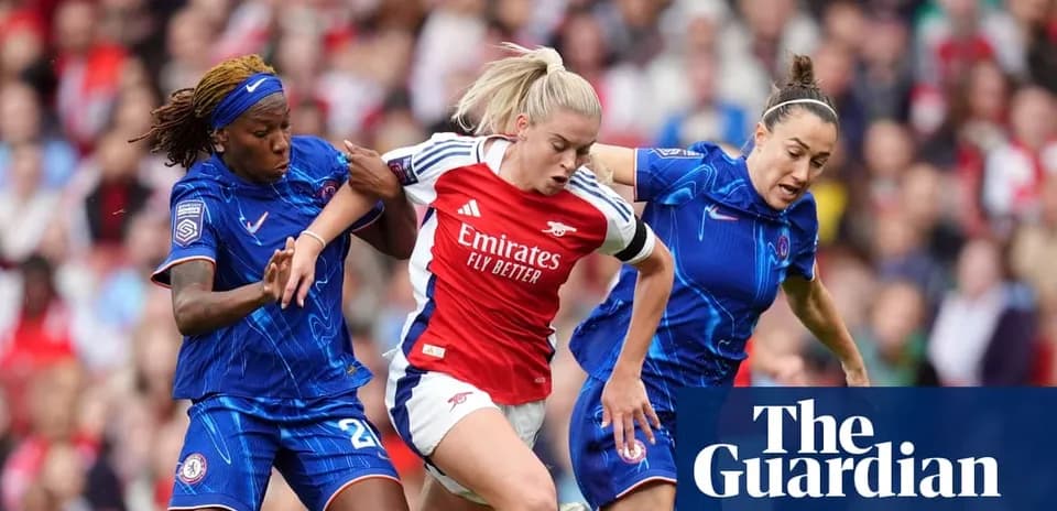 Player in red being challenged by two defenders