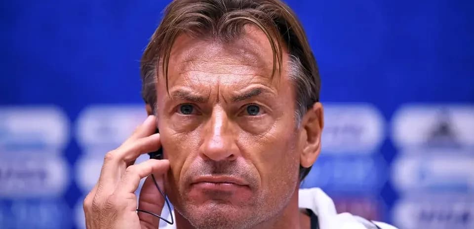 Coach at press conference with earpiece in ear