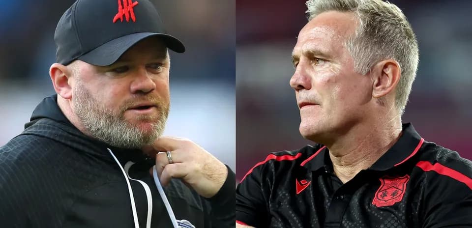 Two football managers in profile during match