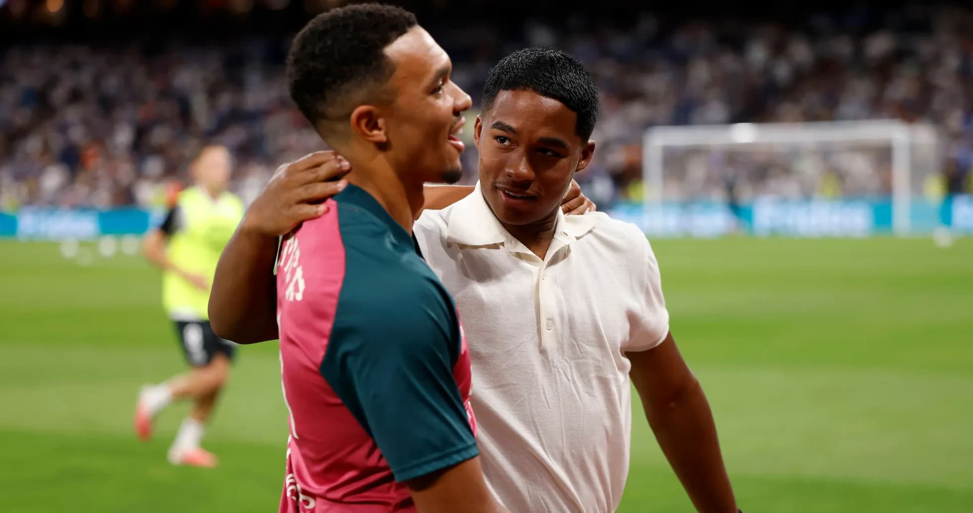 Two players embracing on the football pitch