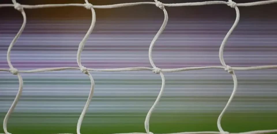 Close-up of football goal net with blurred background