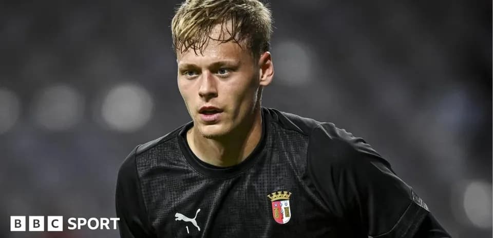 Goalkeeper in black kit during match warm-up