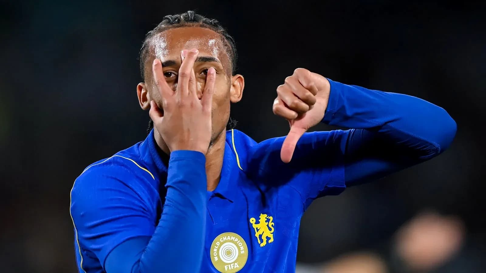 Player celebrating with hand gestures in blue jersey