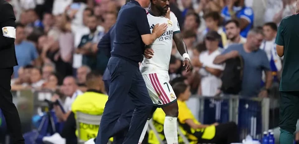 Coach and player interacting on the sidelines