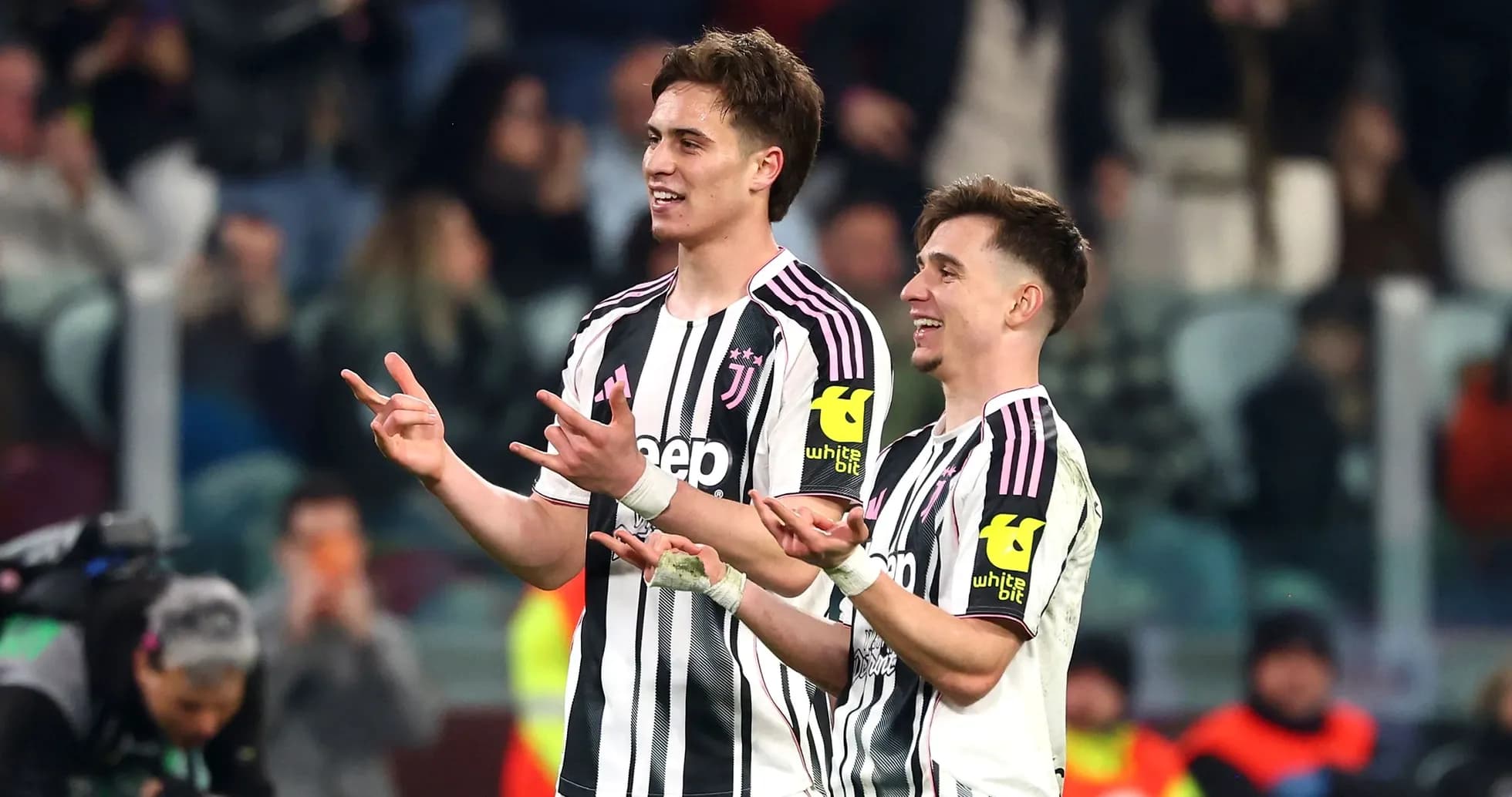 Two Juventus players celebrating on the pitch