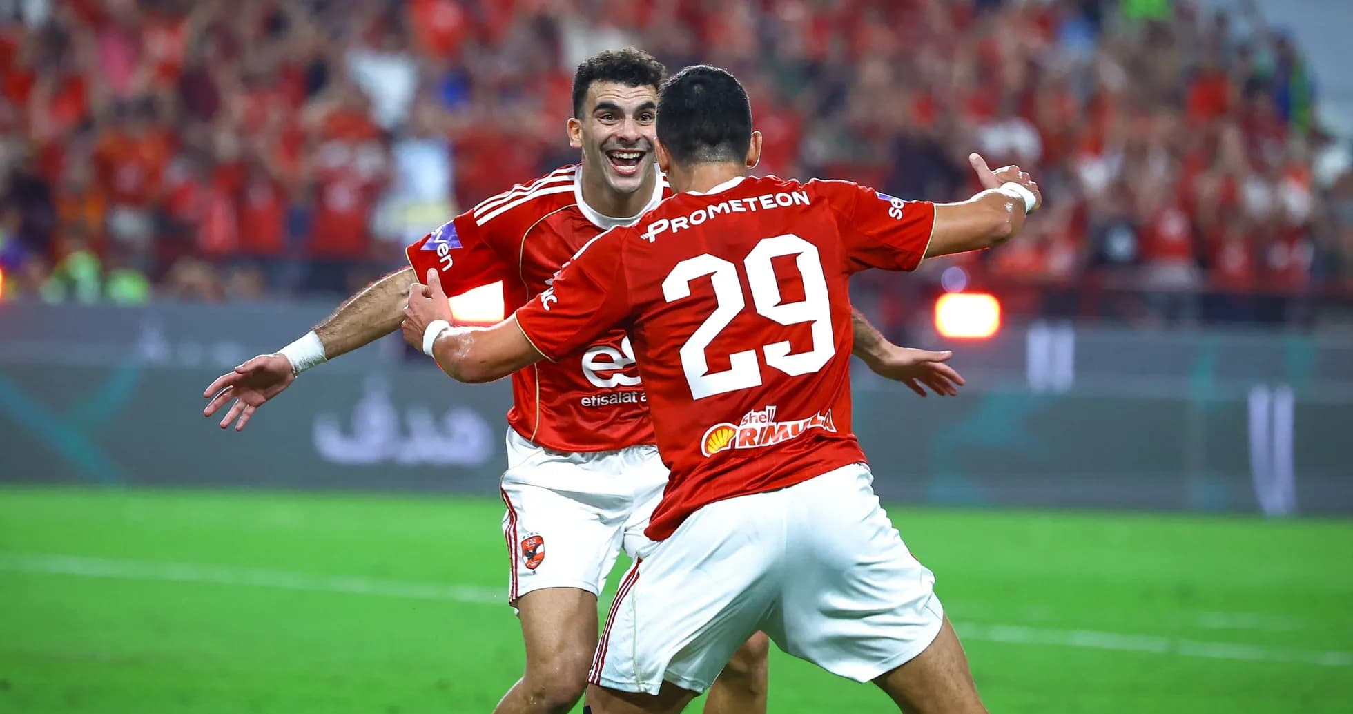 Two players celebrating a goal on the field