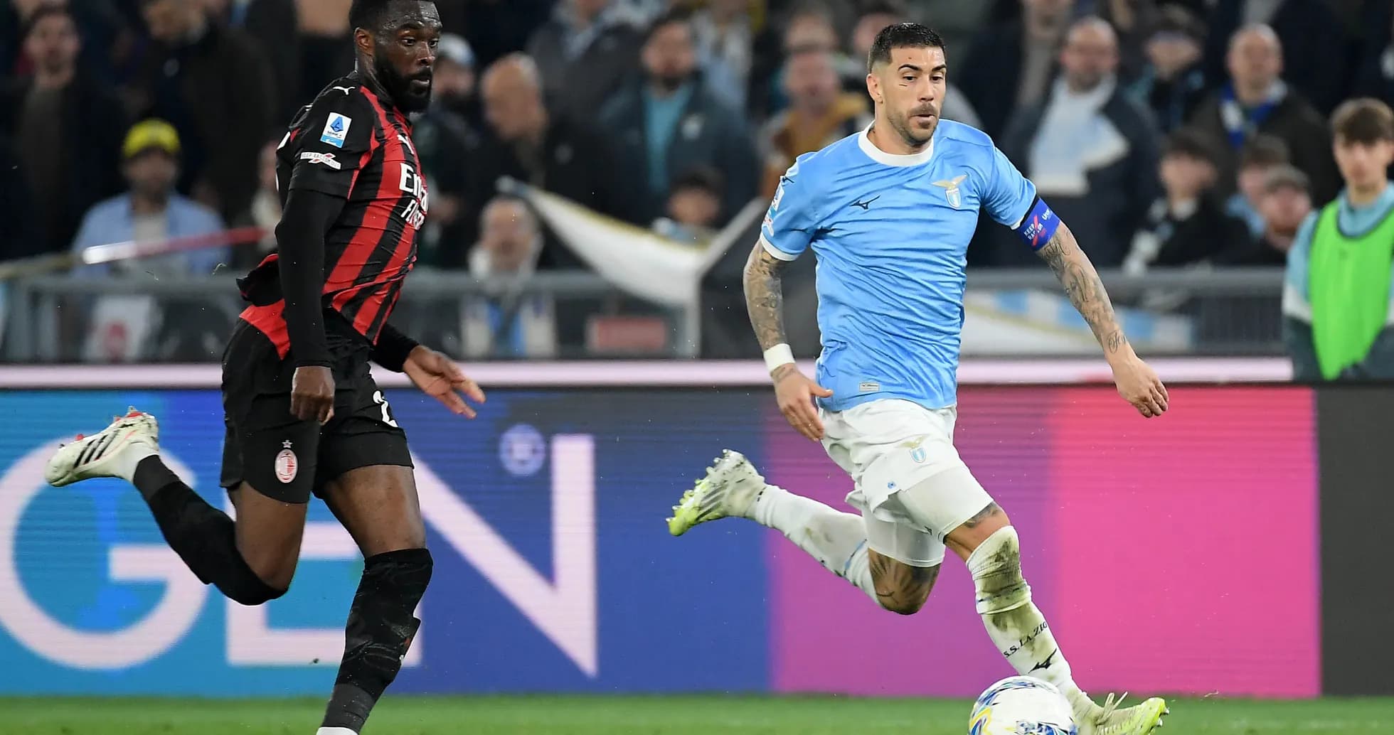 Lazio player dribbling past AC Milan defender
