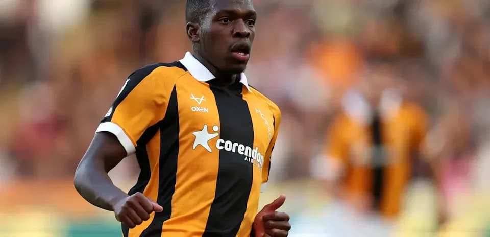 Player in black and orange jersey during match