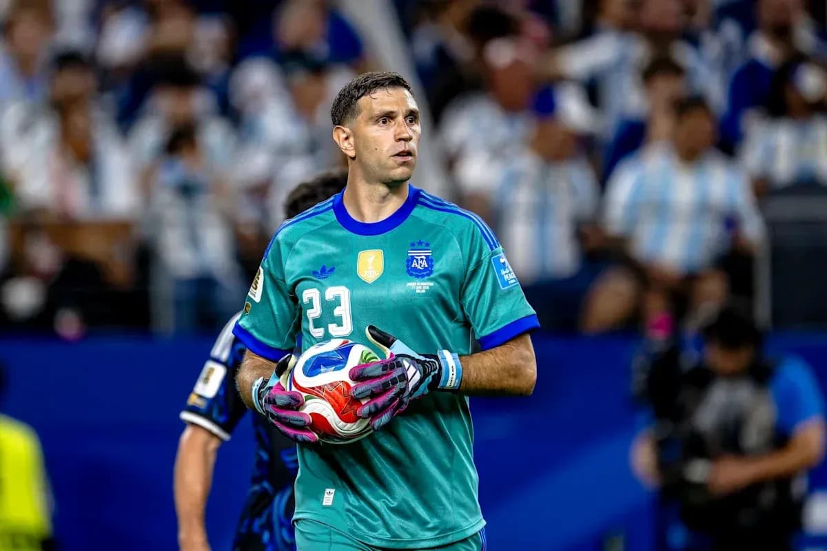 Goalkeeper in green kit holding a soccer ball