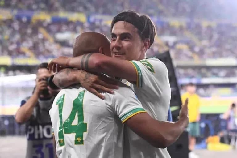 Players celebrating with an embrace on the field