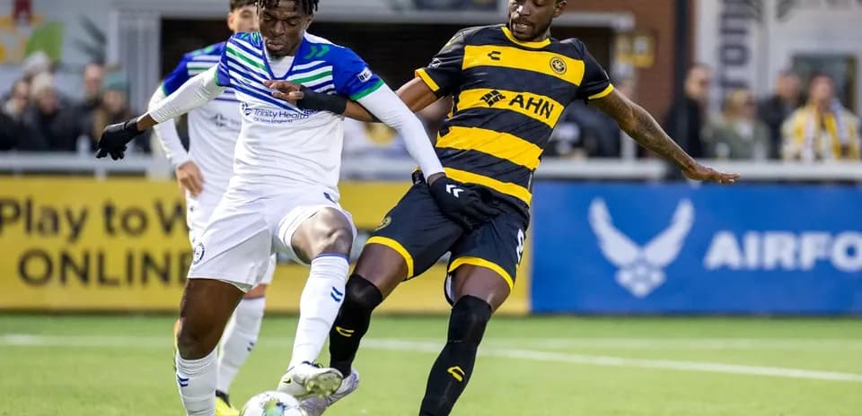 Players competing for the ball in USL match