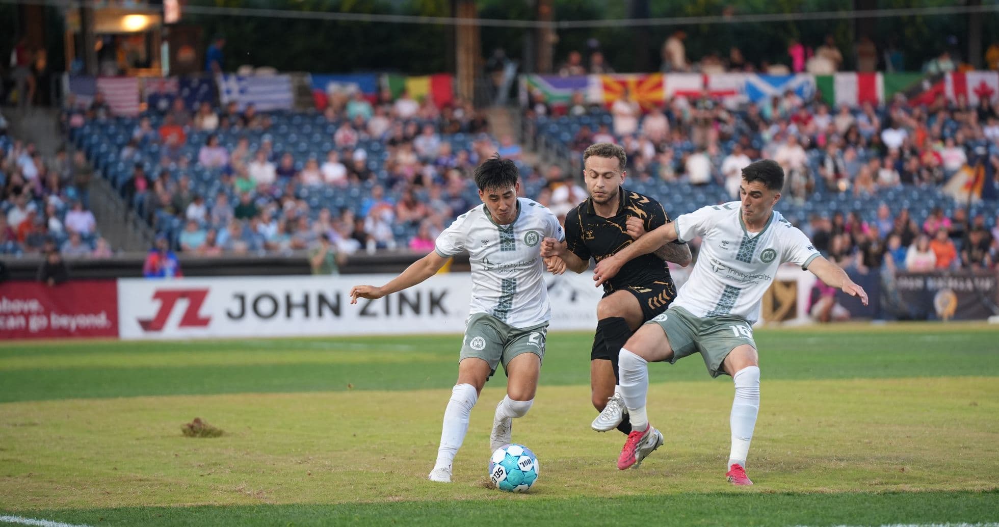 Two players contesting the ball during match