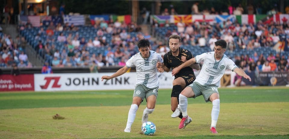 Two players contesting the ball during match