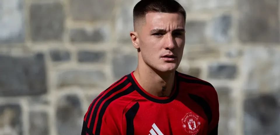 Player in red Manchester United training kit outdoors