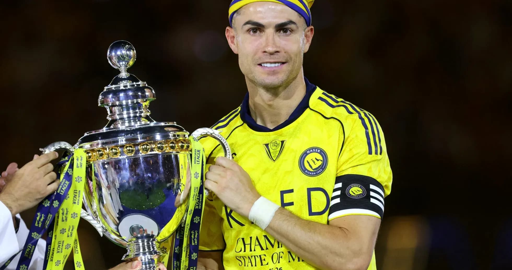 Player holding trophy after winning match