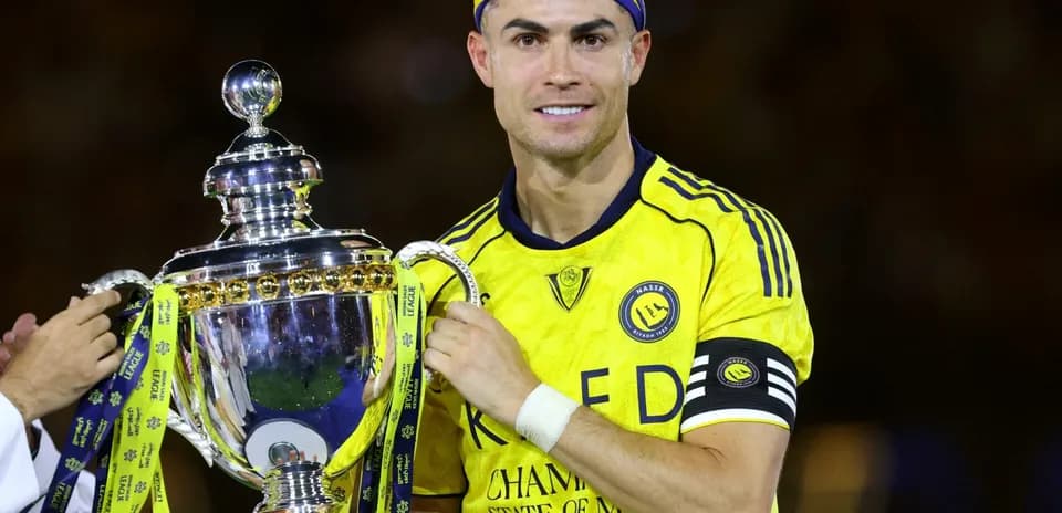 Player holding trophy after winning match