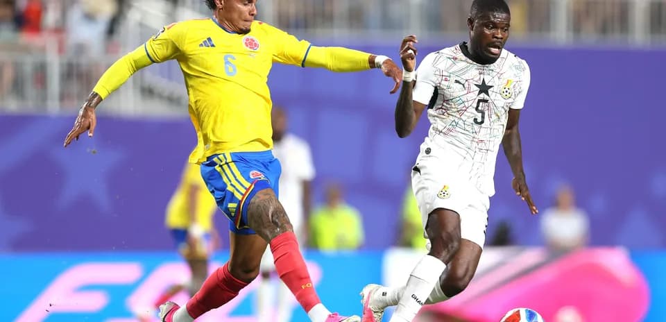 Colombian player tackles Ghanaian opponent during match