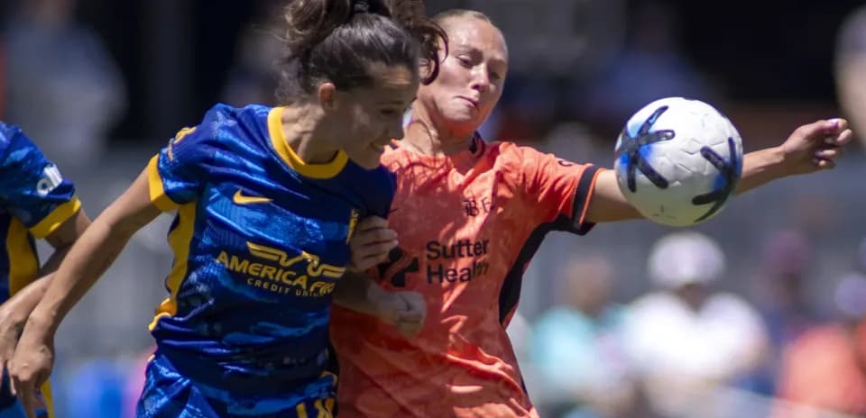 Two players competing for the ball in match