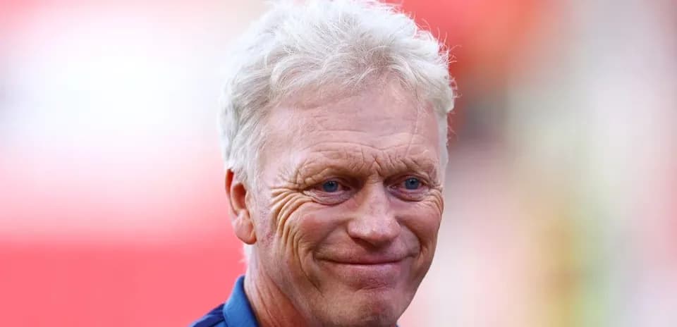 Football manager smiling during pre-match warm-up