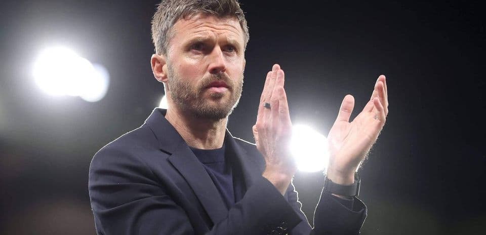 Coach applauding during a match at night
