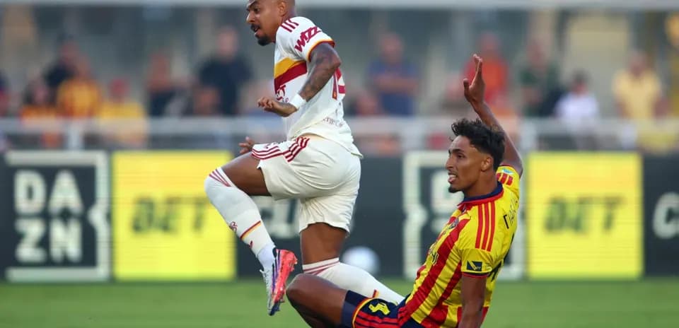 Lecce player tackling AS Roma opponent during match