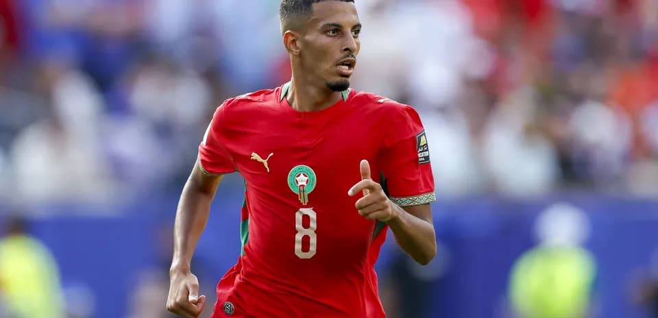 Player in red Morocco jersey running on field