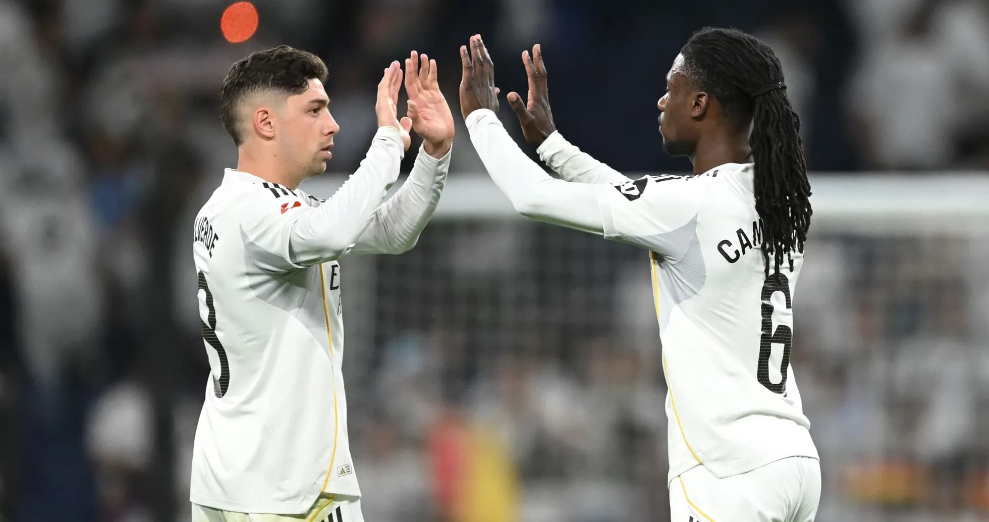 Two players celebrating with high-fives on field