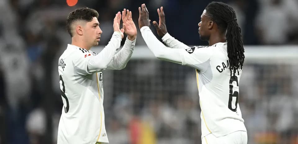 Two players celebrating with high-fives on field