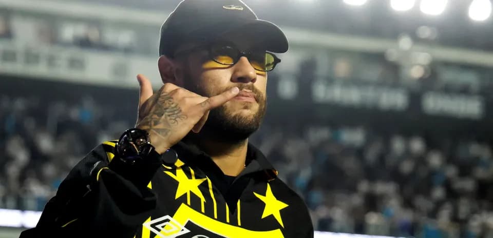 Person in sunglasses making a gesture at event