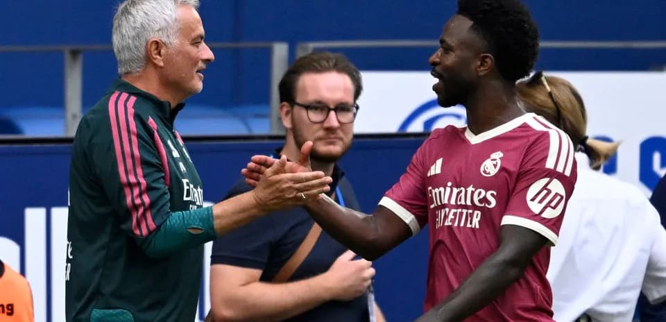 Manager and player shaking hands during match
