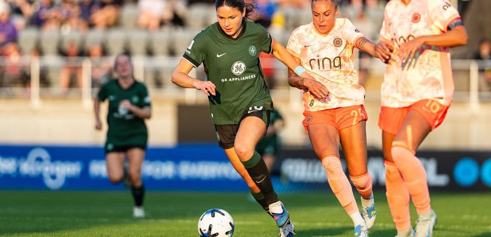 Player advancing with the ball in NWSL match