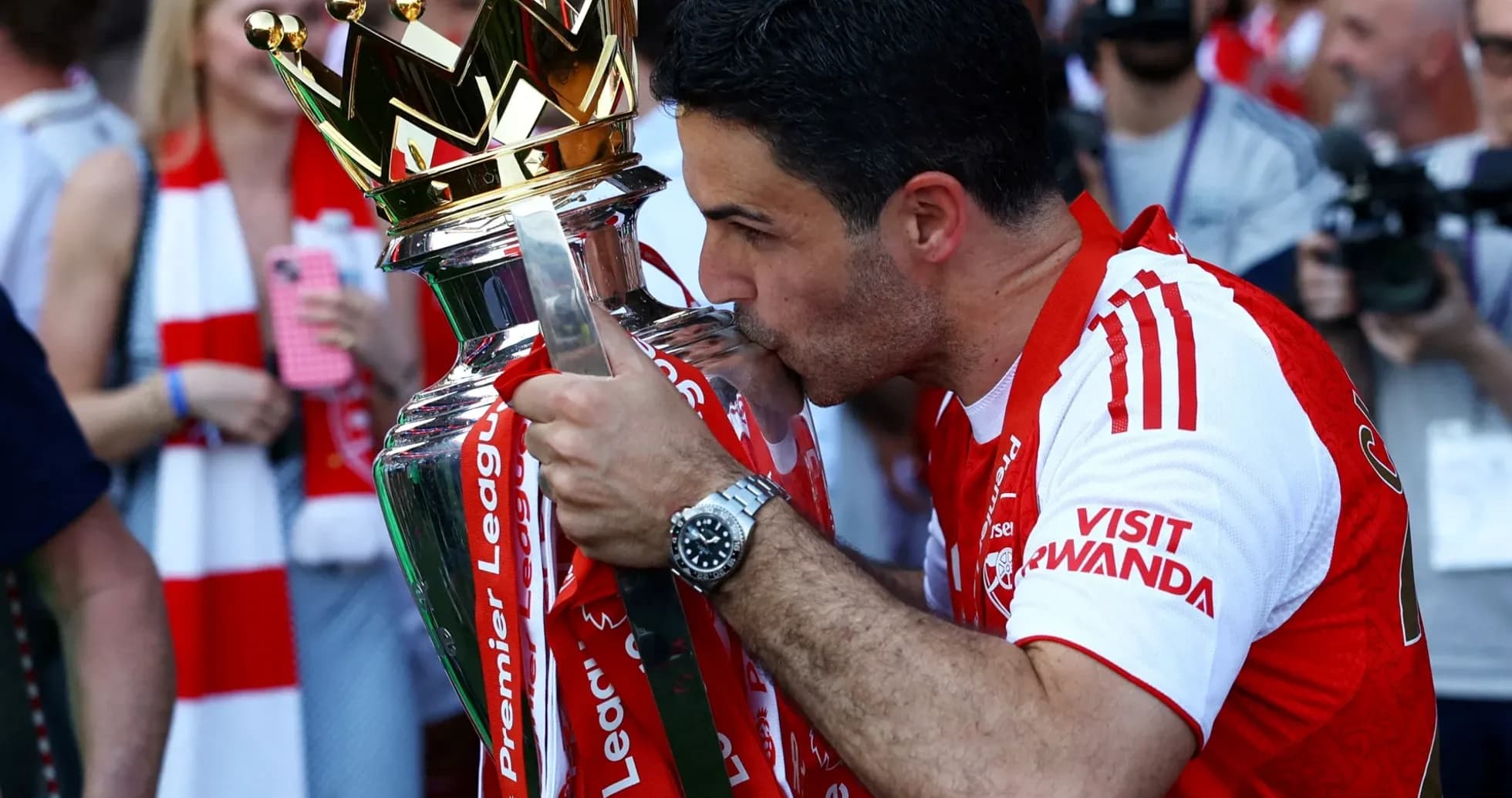 Manager kissing Premier League trophy during celebration